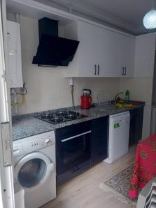 a kitchen with a washer and a washing machine at MEYDANDA 1+1 DAİRE in Trabzon