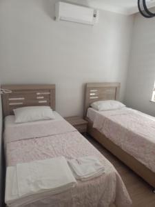 two beds sitting next to each other in a bedroom at MEYDANDA 1+1 DAİRE in Trabzon