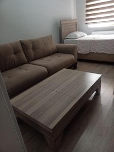 a living room with a couch and a coffee table at MEYDANDA 1+1 DAİRE in Trabzon