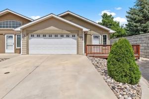 a house with a driveway and a garage at Convenient Townhouse - Near Airport in Rapid City