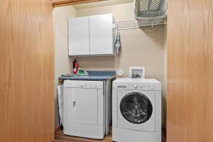 a kitchen with a washing machine and a washer at Convenient Townhouse - Near Airport in Rapid City