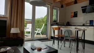 a kitchen with a table and chairs next to a window at Huisje de Linde in Wolvega