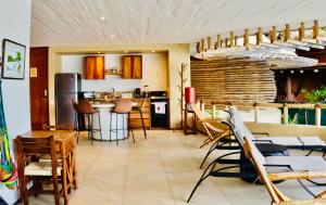 a kitchen and dining room with a table and chairs at Casa de Ali: Located on the beach! in Zihuatanejo