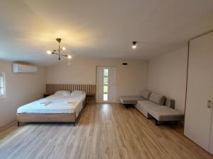 a large room with two beds and a couch at Superb Apartments Virpazar in Virpazar