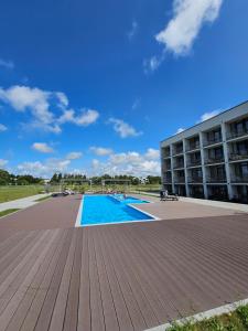 a large swimming pool in front of a building at Mindaugo apartamentai su šildomu baseinu, sporto sale, vaikų kambariu, work zona in Palanga