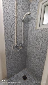 a shower with a shower head in a bathroom at CITRA INN in Tangerang