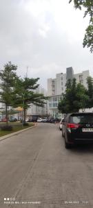 a parking lot with cars parked in front of a building at CITRA INN in Tangerang
