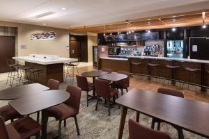 a restaurant with tables and chairs and a bar at Courtyard by Marriott Pittsburgh Washington Meadow Lands in Washington