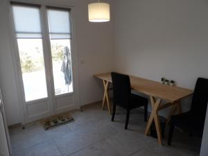 Un comedor con mesa y sillas de madera. en Villa de standing, en Calvi