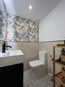 a bathroom with a white sink and a toilet at Emilysuites - Malaga Centro Historico in Málaga