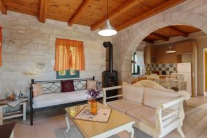 a living room with a couch and a table at Villa Terpsichore St George Retreat BY APOKORONAS-VILLAS in Kókkinon Khoríon