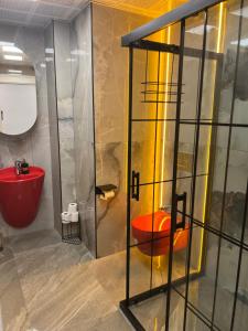 a bathroom with an orange toilet in a room at Sea town utku in Antalya