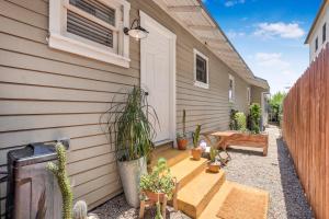 a patio with potted plants next to a house at Cactus Room - Private Entrance in Santa Barbara