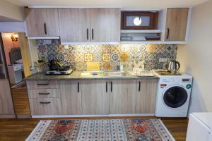 a kitchen with a sink and a washing machine at Fidelya Boutique Hotel in Istanbul