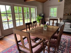 a dining room with a wooden table and chairs at Guesthouse 't Oeyenbos in Knegsel