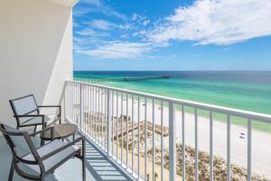 a balcony with two chairs and the beach at SpringHill Suites by Marriott Panama City Beach Beachfront in Panama City Beach