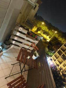 two benches sitting on a balcony at night at Studio Concept Apartment in Zagreb