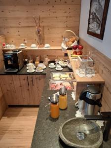 a kitchen with a counter with food on it at Kingershof in Galtür