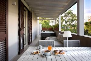 a breakfast table on the balcony of a house at Montespina Park Hotel in Naples