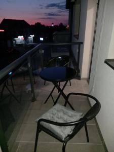 a chair sitting on a balcony with a view at Sweet home in Brčko