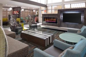 a lobby with a fireplace and chairs and a tv at Residence Inn by Marriott Temecula Murrieta in Murrieta