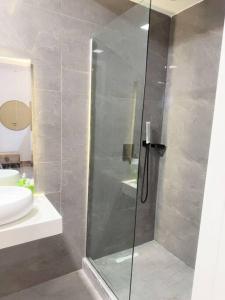 a bathroom with a shower with a glass door at Brand New Exclusive Condo with Pool and Gym in Port Harcourt
