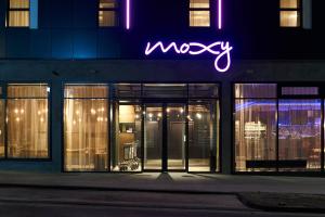 a neon sign on the side of a building at Moxy Essen City in Essen