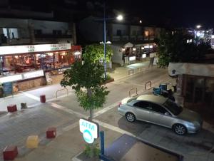 un'auto parcheggiata in un parcheggio di notte di BluejSuite a Ayia Napa