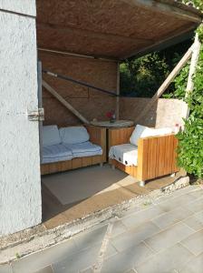 a patio with two beds and a table at Chambre chez l'habitant les garrigues in Piolenc
