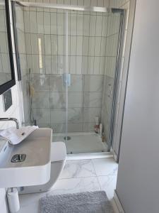 a bathroom with a shower and a sink at Seaside Luxury Retreat in Southend-on-Sea +9 photos