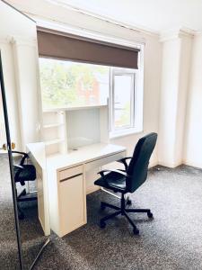 an office with a desk and two chairs and a window at Private Room close to Leeds University and City centre in Leeds