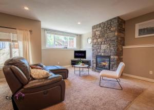 a living room with a couch and a fireplace at Peaceful 2 BD Oasis, Bsmt Suite, Private Terrace, Near YQL in Lethbridge