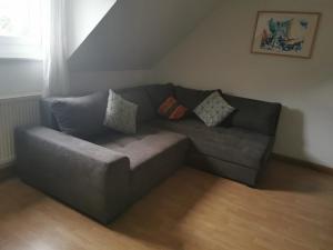 a couch in a living room with pillows on it at s´Paradies Ferienwohnung in Beilngries