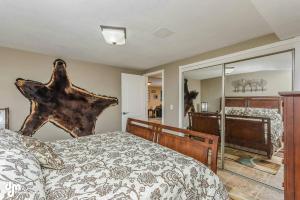 a bedroom with a large bed and a large mirror at Lakefront Perfect for Families/Corporate Rentals in Wasilla