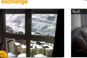 a view of a snowy mountain from a window at DUPLEX ALCAZABA con parking gratuito, 2 dormitorios , 5pax in Sierra Nevada