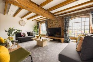 a living room with a brick wall at Wild Roses Serviced Apartments - ExCel Warehouse 2 in London