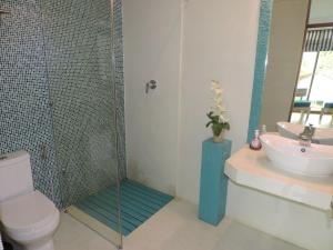 a bathroom with a shower and a toilet and a sink at Binnacle Negombo in Negombo