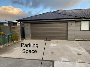 a garage with a parking space sign in front of it at 2 Bedroom Unit in Queenstown in Frankton Wharf