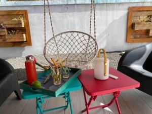 a chair and a table with a tray with drinks on it at Kaz bleu karaibes in Sainte-Anne