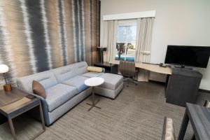 a living room with a couch and a flat screen tv at Residence Inn by Marriott Reno Sparks in Sparks