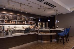 un restaurante con un bar con taburetes azules en Courtyard by Marriott Raleigh-Durham Airport/Brier Creek, en Raleigh