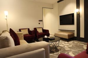 a living room with couches and a flat screen tv at نيلوفر - Nilover in Tabuk