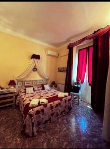 a bedroom with a large bed with red curtains at B&B Casa Celsi in La Spezia