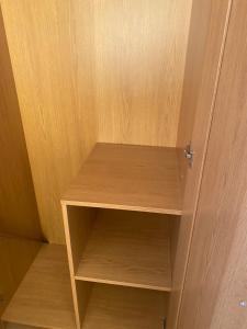 a wooden cupboard with a wooden shelf in it at IServe in Parkside