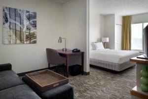 a hotel room with a bed and a desk at SpringHill Suites Danbury in Danbury