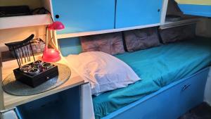 a bunk bed with a desk and a hat on it at La Perle d'orient A man donné in Gruissan