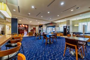 a lobby with tables and chairs and a cafeteria at Courtyard Biloxi North/D'Iberville in Biloxi