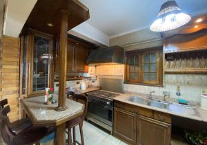 a kitchen with a sink and a stove at Heliopolis pearl/ furnished apartment in Cairo