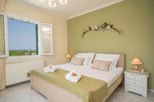 a bedroom with a large bed with towels on it at Ariadni Sea View Apartment in Minia