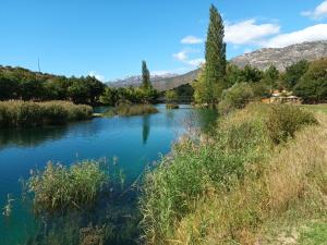a view of a river with mountains in the background at Sunset1, free private parking, pets welcome in Privlaka